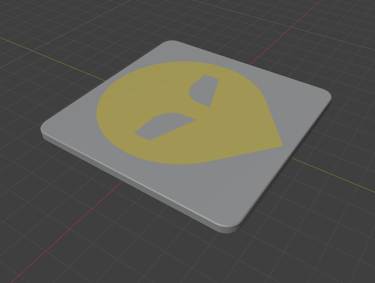 A square coaster with a rounded alien-face icon in gold